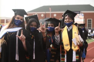 LU students pose in their graduation caps and gowns at graduation